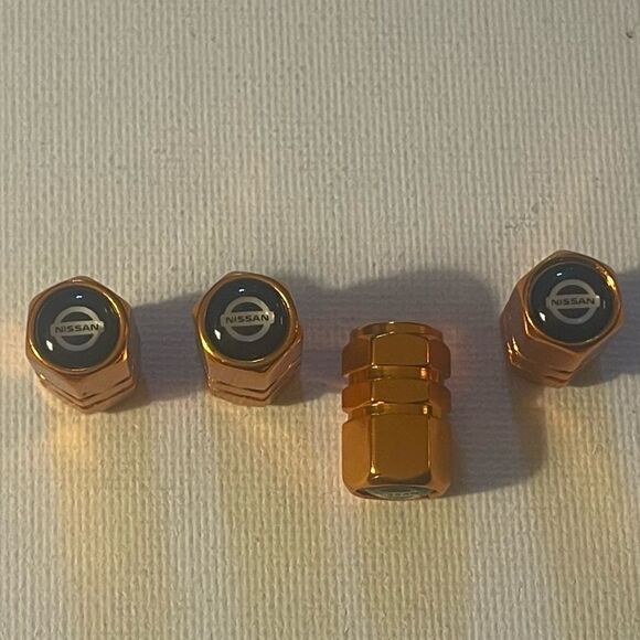 Nissan Logo Valve Stem caps in Gold set of 4 NWT - Picture 1 of 4